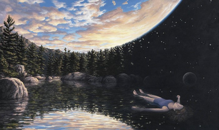 Woman floating in water under a split sky and planet