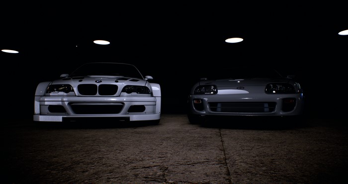 BMW M3 GTR and Toyota Supra in dark garage