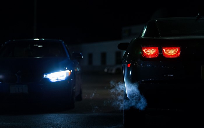 4K Night shot of Chevrolet Camaro and BMW