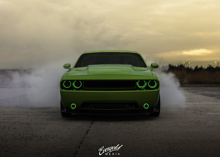 Green Dodge Challenger doing a burnout