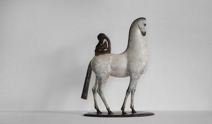 Copper sculpture of a horse with a rider