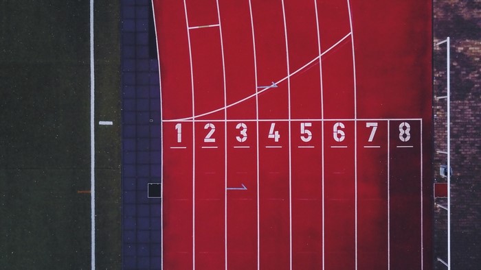 Aerial view of a running track with numbered lanes