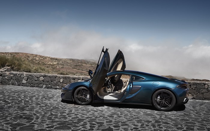 McLaren 570S with scissor doors on a stone road
