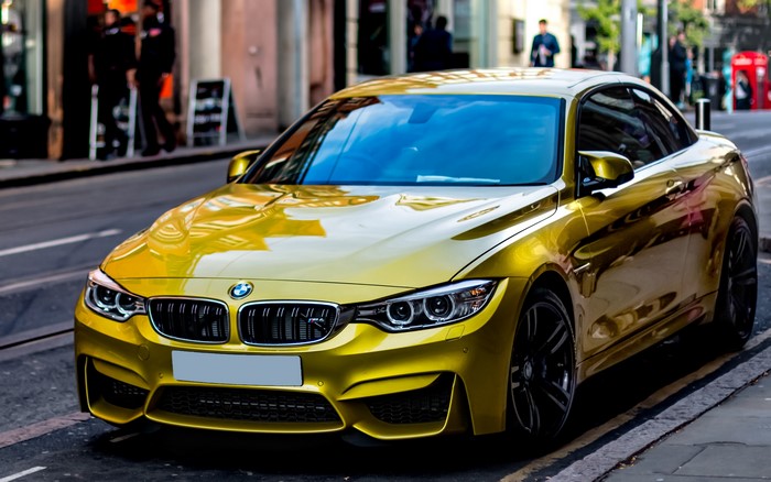 Yellow BMW M4 Coupe on a City Street