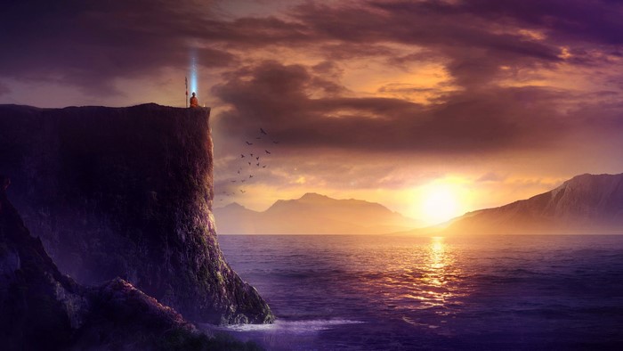 Monk meditating on cliff at sunrise