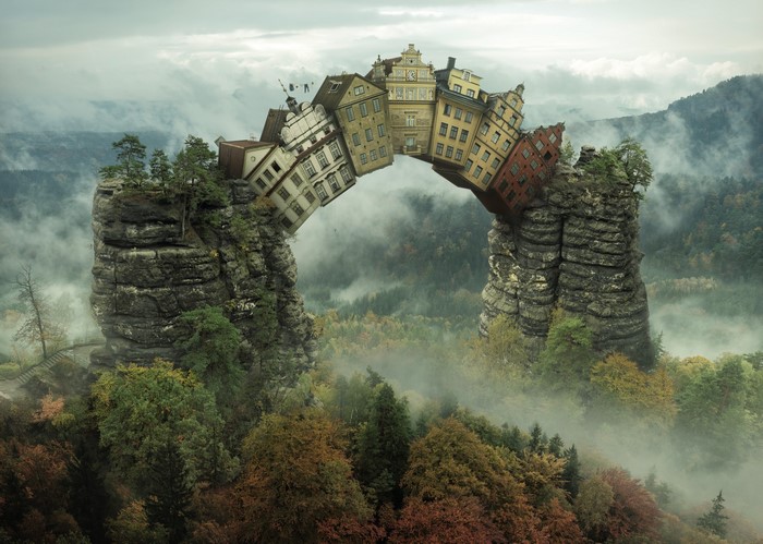 Surreal houses forming a bridge between rocky outcrops