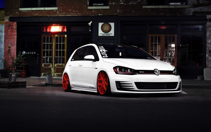 White Volkswagen Golf GTI with red wheels