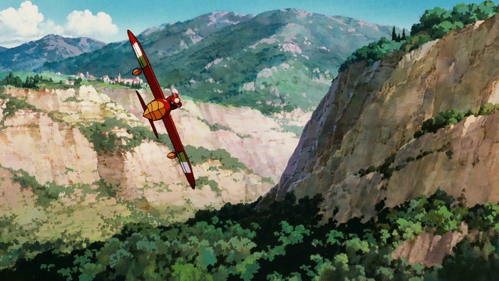 Porco Rosso flying over a mountainous landscape