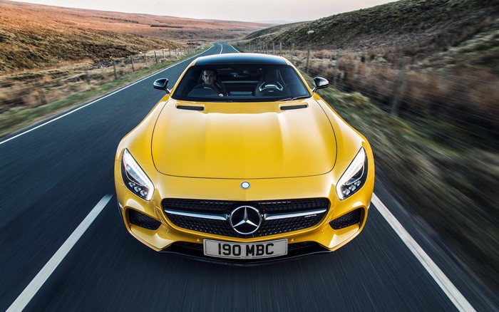 Yellow Mercedes-AMG GT Driving on a Road