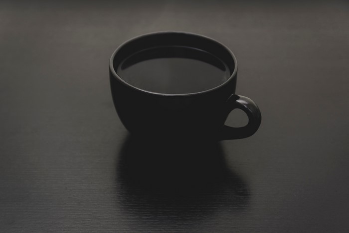 Black coffee cup on a dark surface