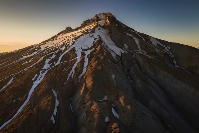 Mountain peak with snow and sky at sunset