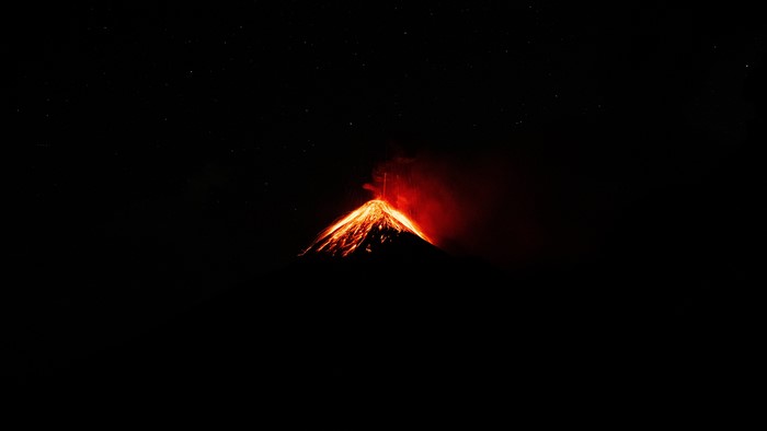Volcán de Fuego eruption under starry night sky