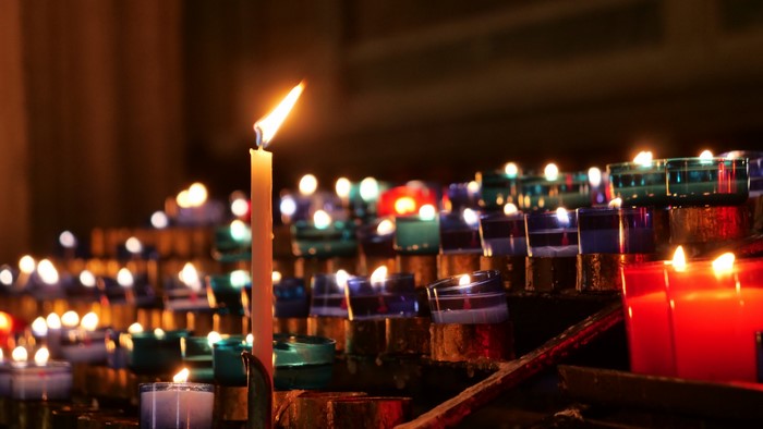 Church candles lit in rows