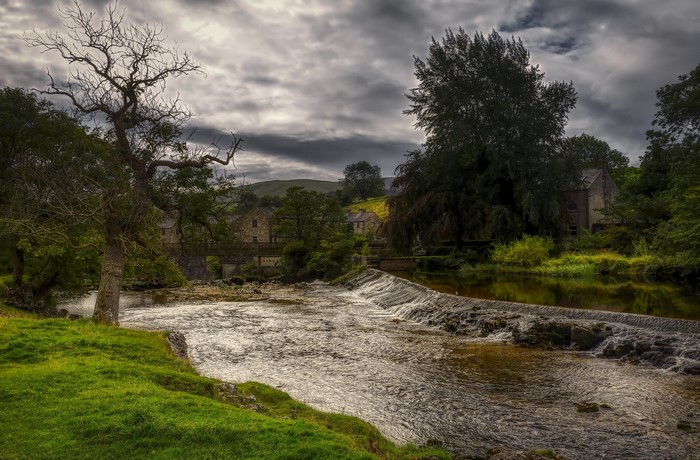 River and stone buildings in England