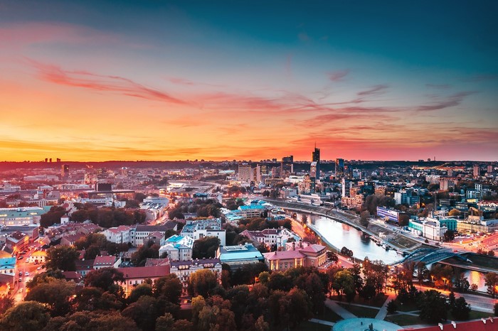 Vilnius cityscape at sunset with river and modern buildings