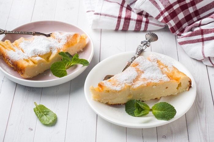 Two slices of cake with powdered sugar and mint
