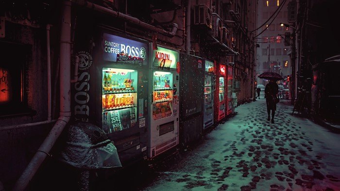 Night alley with vending machines and snow in Japan