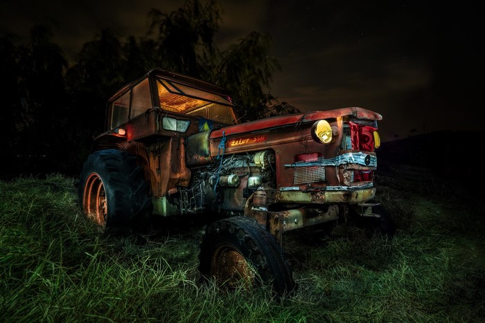 Old rusty Zetor 5511 tractor at night in grass