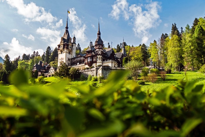 Peles Castle in Romania with Mountains and Trees