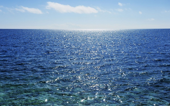 Ocean surface with sun glare and sky