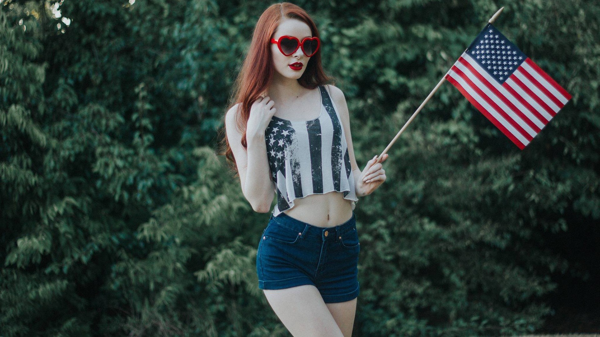 Woman with American flag tank top and heart sunglasses HD Wallpaper