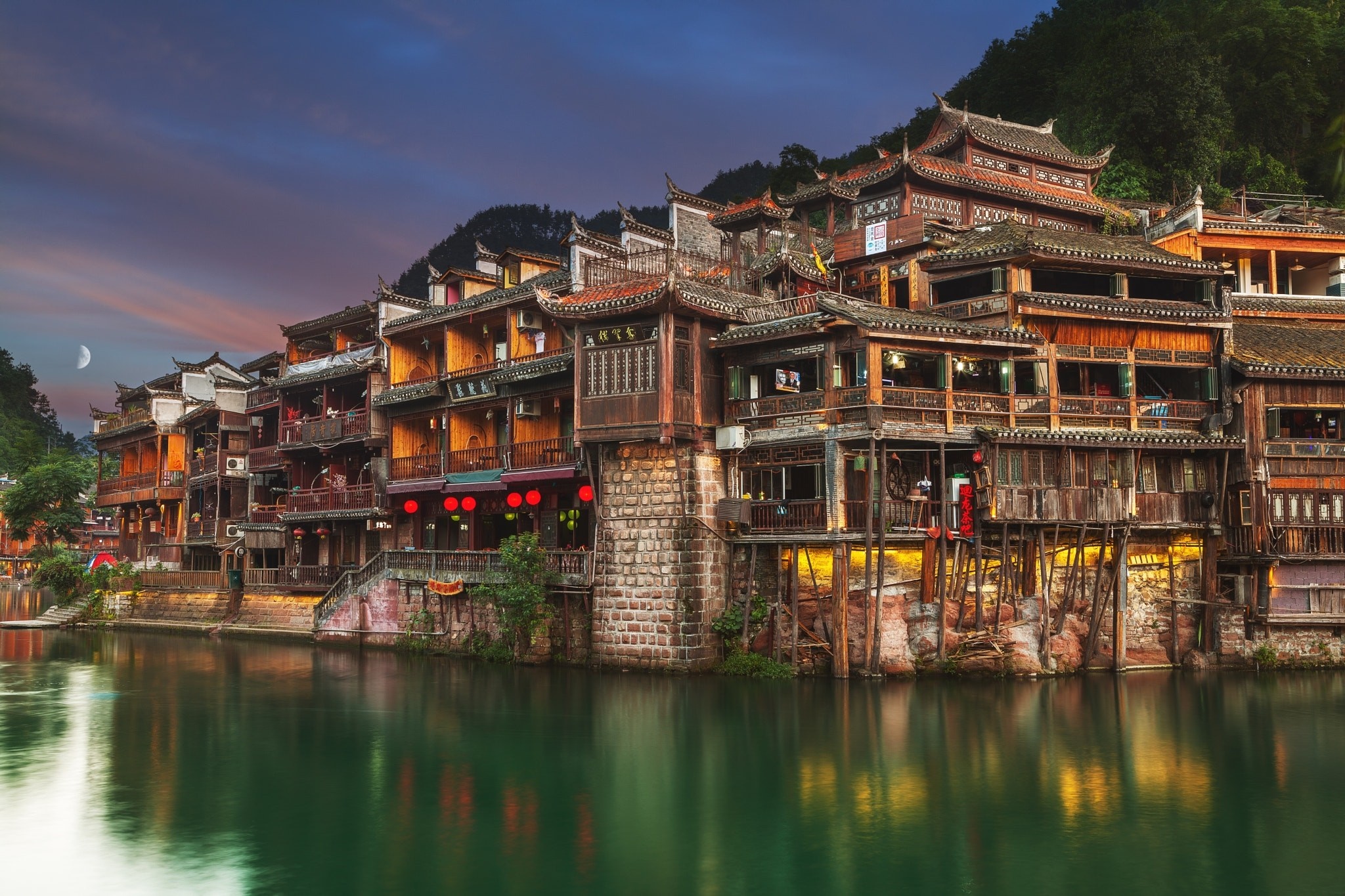 Ancient riverside buildings at dusk with reflections HD Wallpaper
