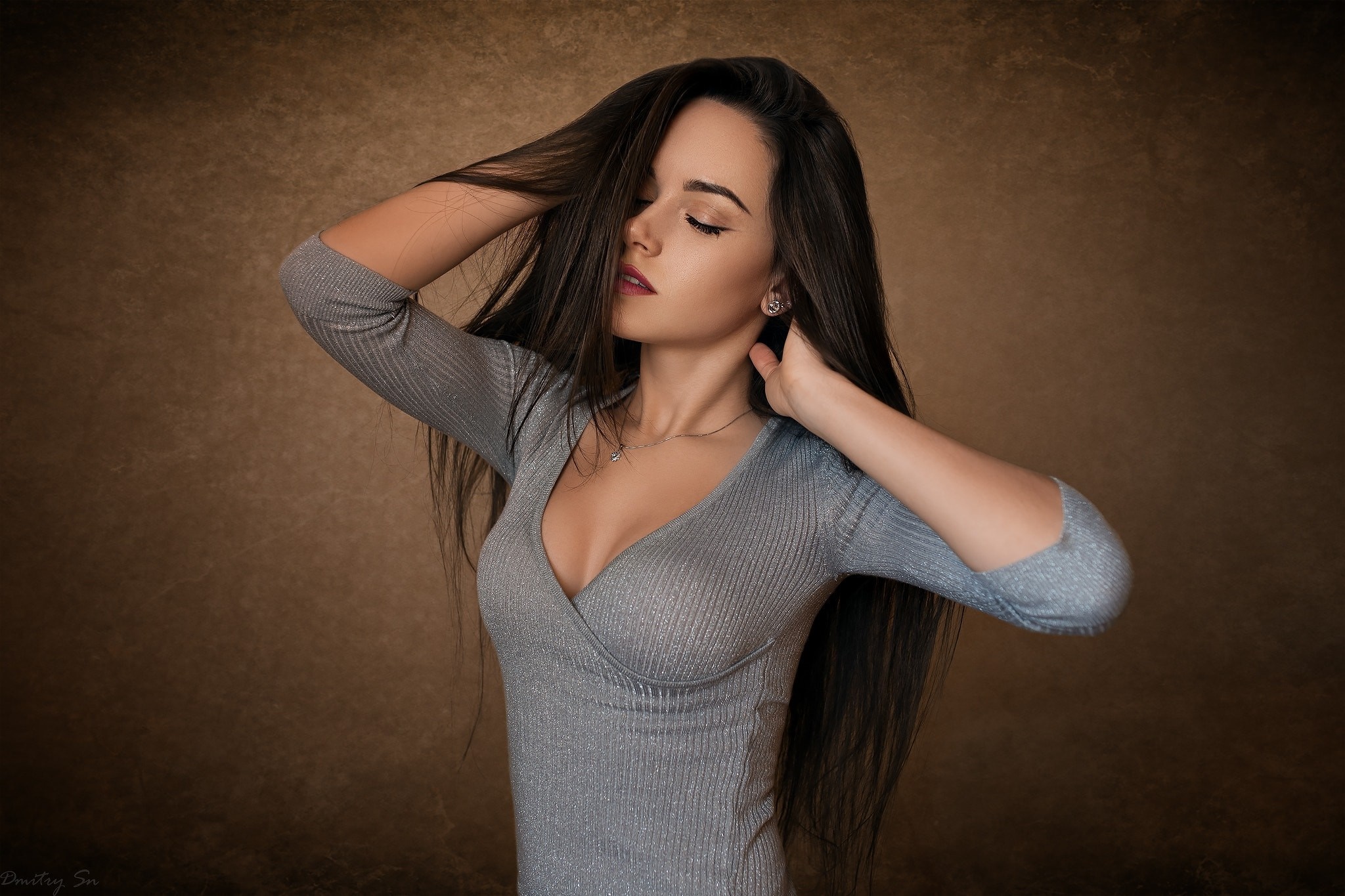 Woman with long dark hair wearing a grey dress HD Wallpaper
