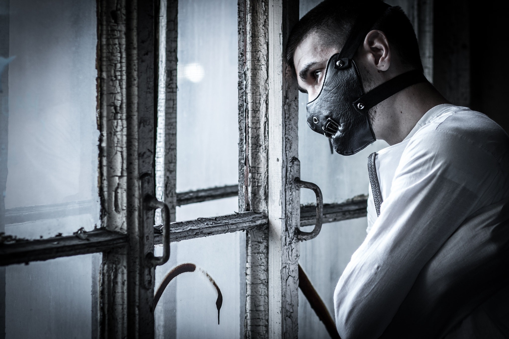 Man in straitjacket and mask by window HD Wallpaper