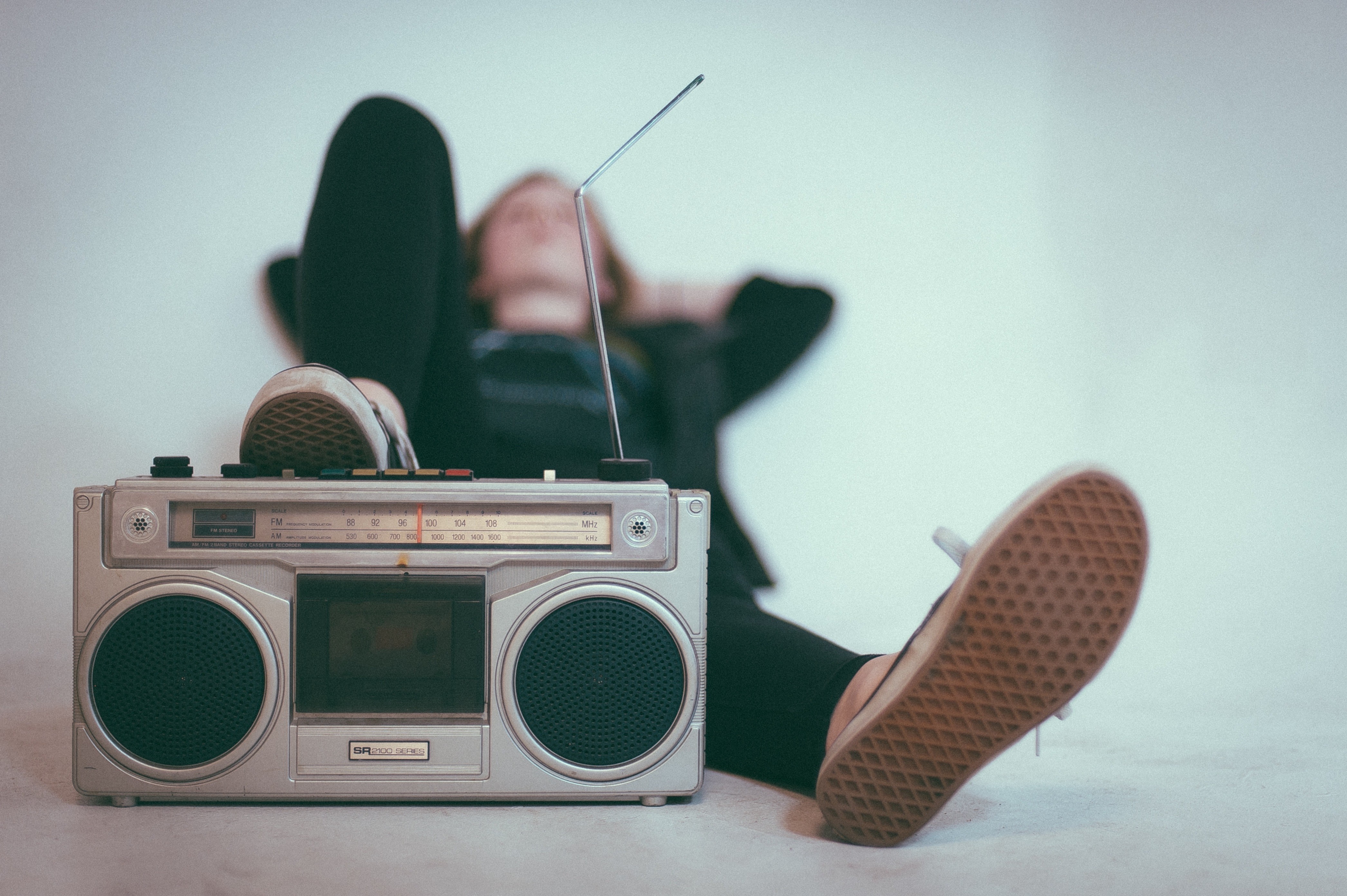 Person lying down with a boombox HD Wallpaper