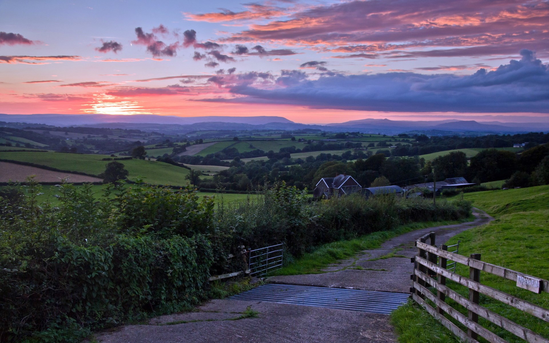 Sunset over rolling green hills and farmland HD Wallpaper