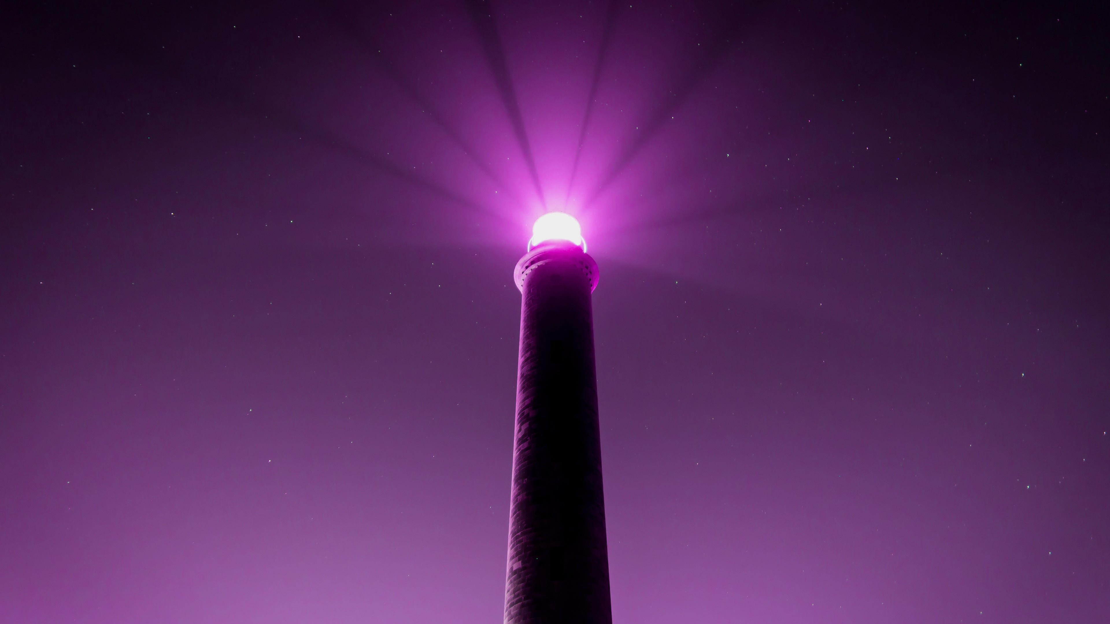 Purple lighthouse beam at night with stars HD Wallpaper