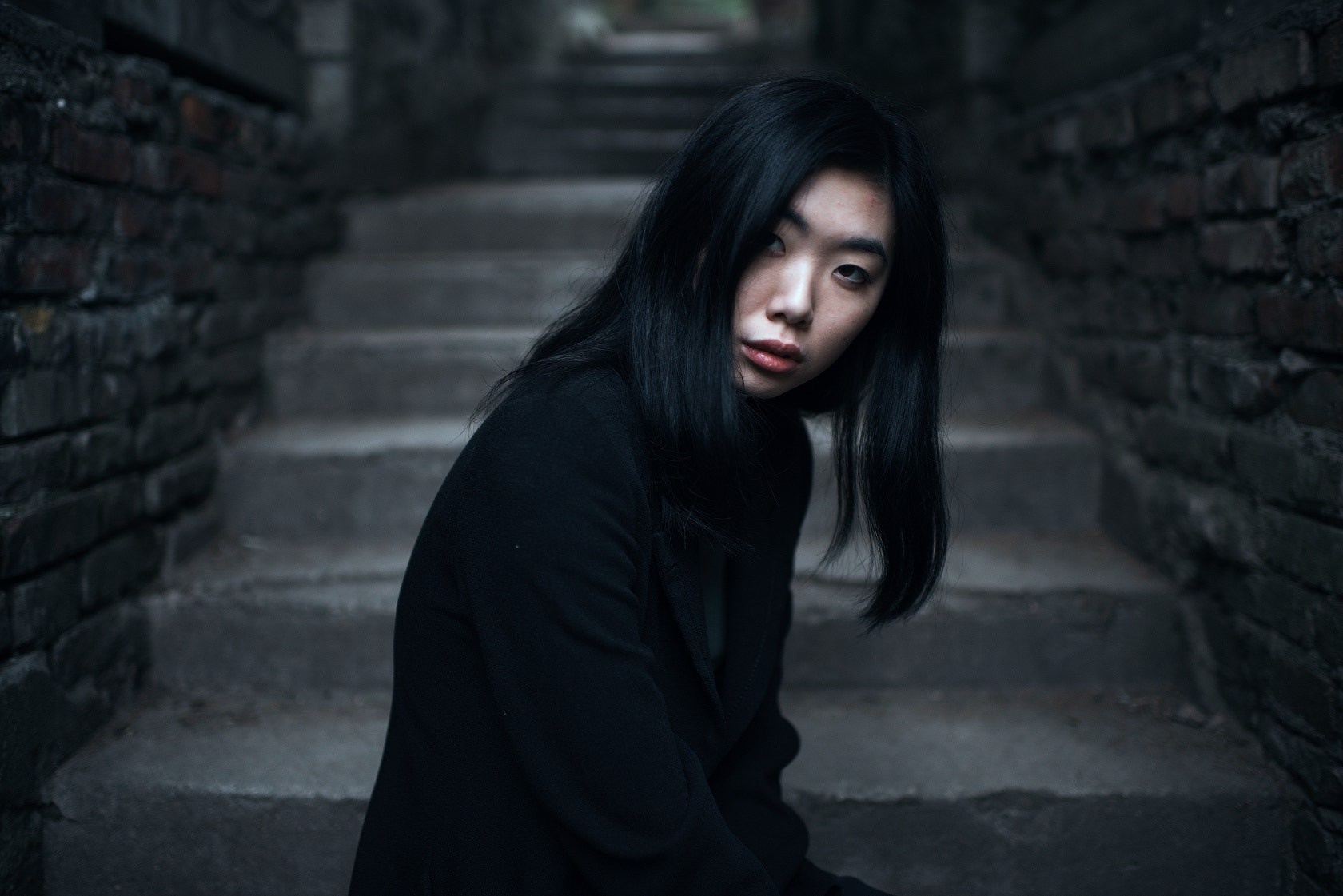 Asian woman in black coat on stairs HD Wallpaper
