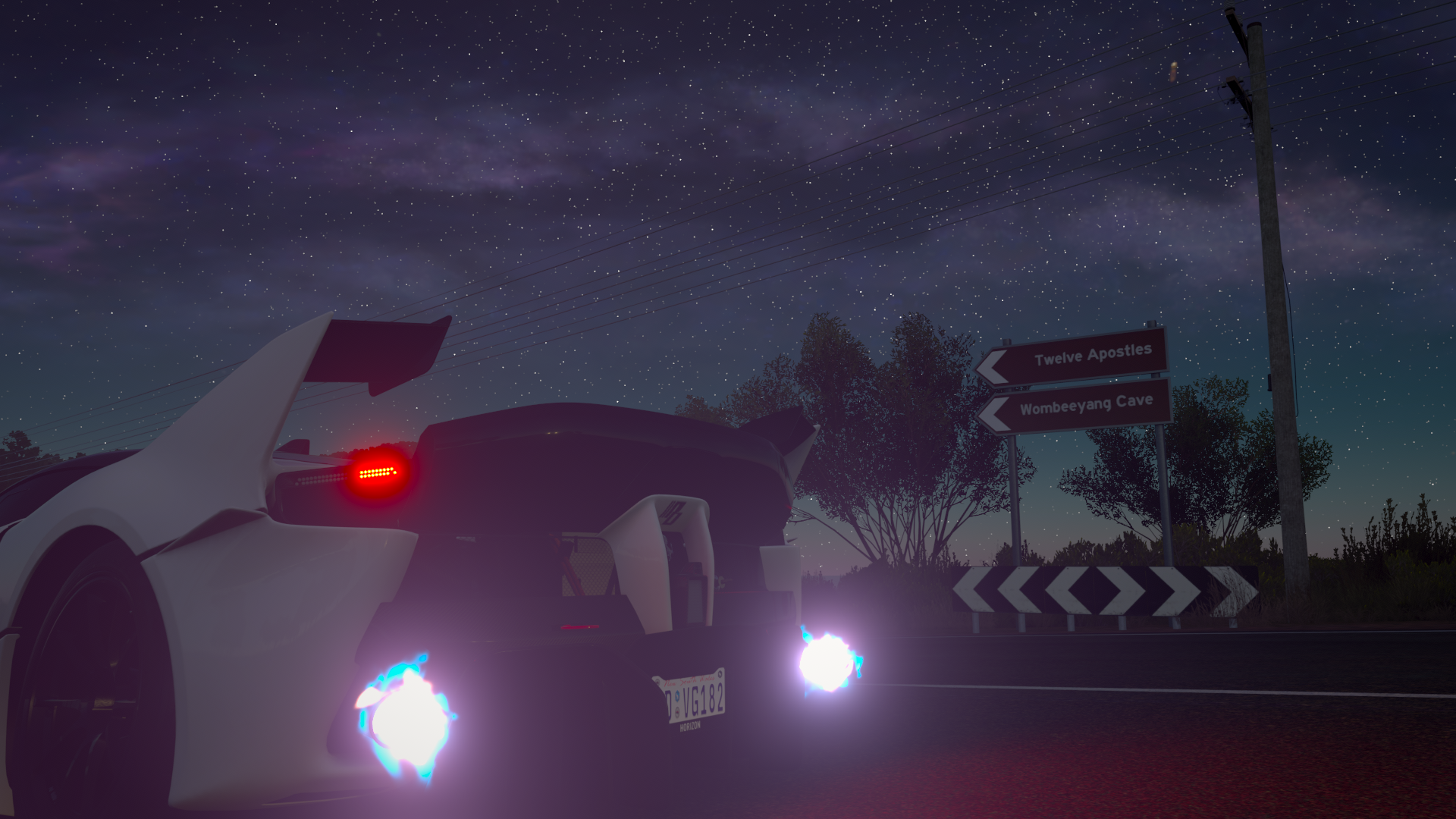 Car at night with star sky and road signs HD Wallpaper