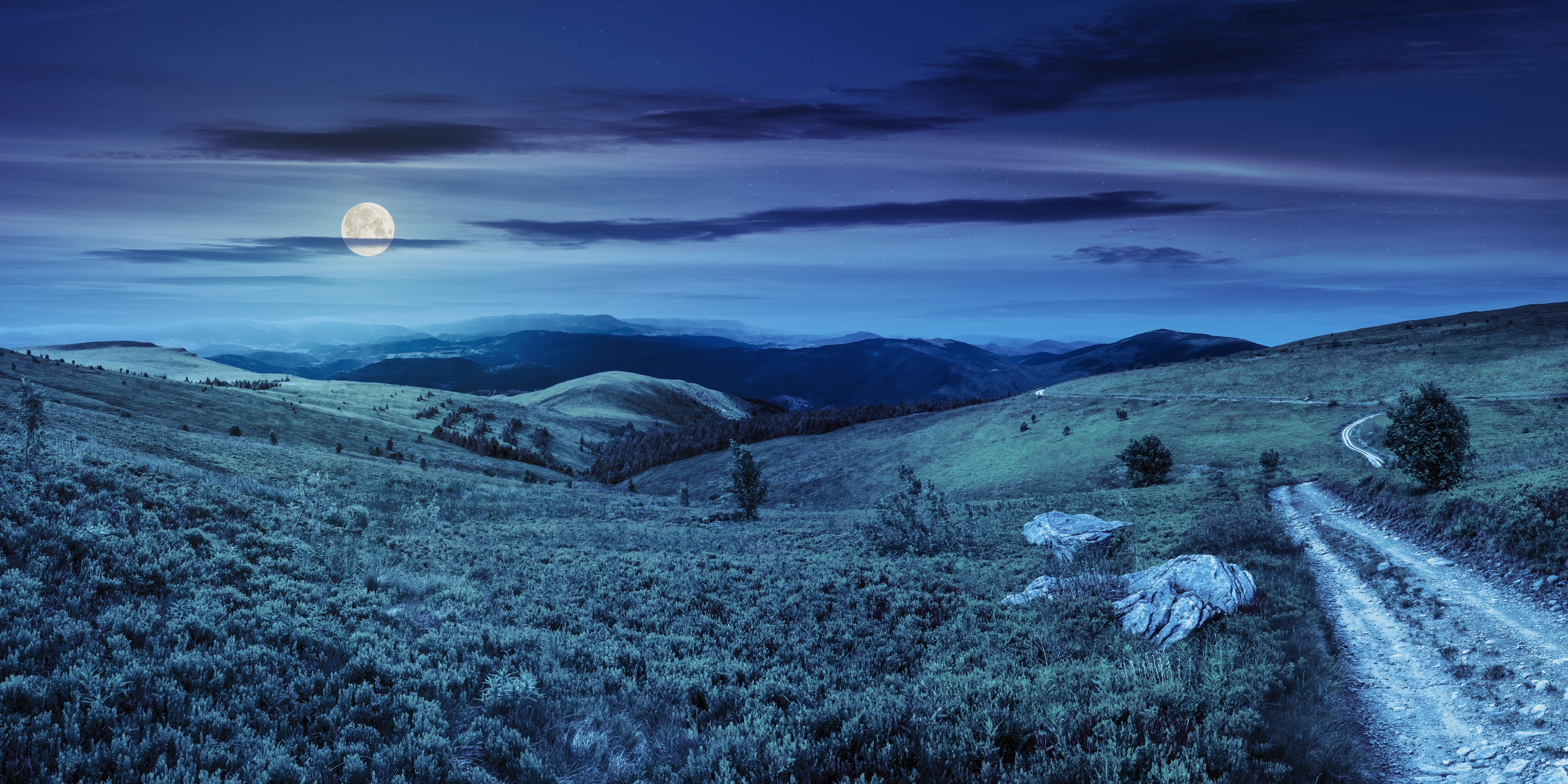 Moonlit mountain landscape with a dirt road HD Wallpaper