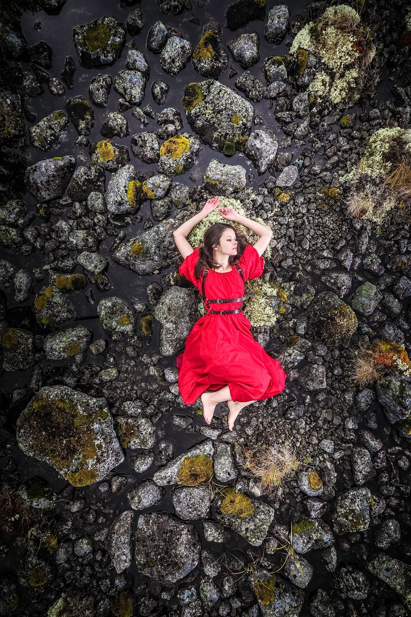 Woman in red dress lying on rocks HD Wallpaper