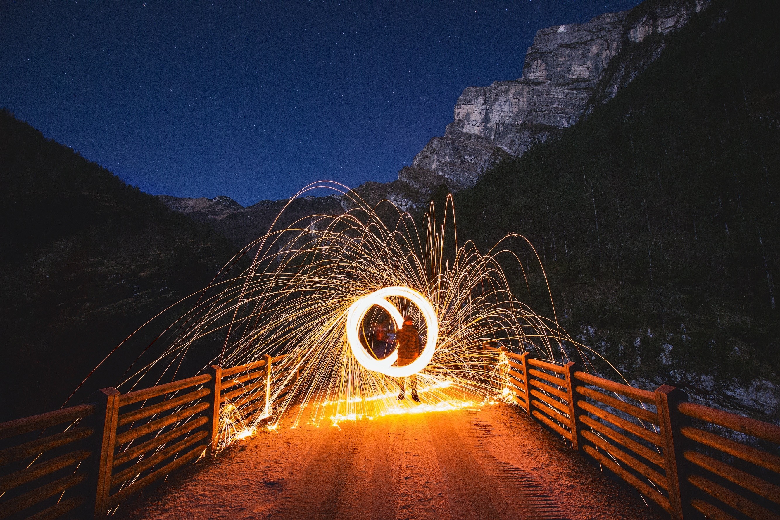 Light painting with sparks on a bridge at night HD Wallpaper