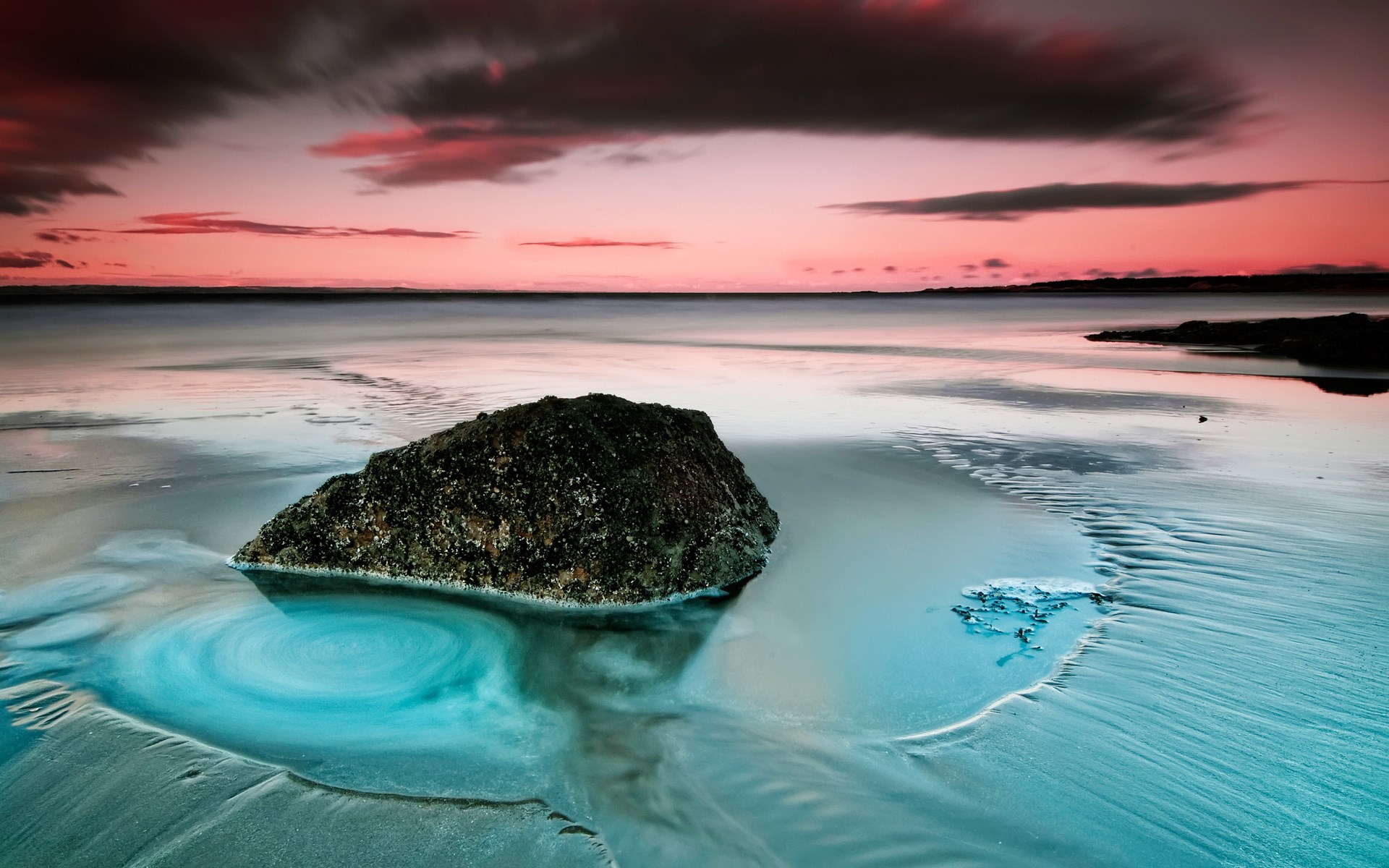 Rock in swirling water at sunset beach HD Wallpaper
