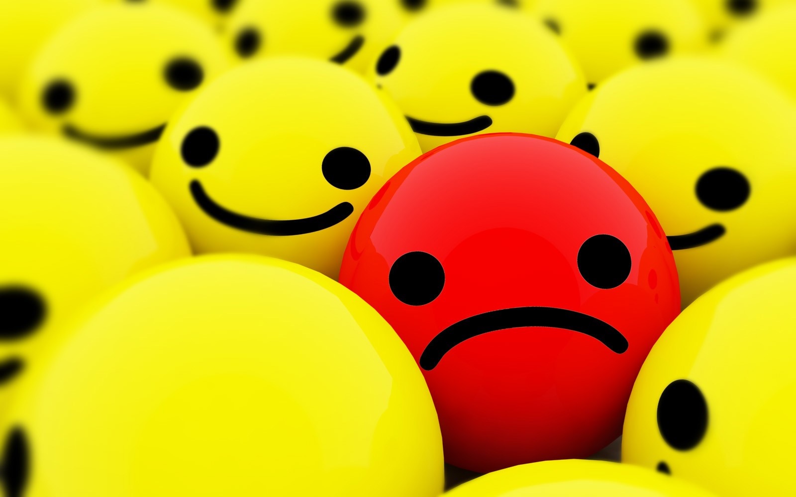Red sad face among yellow happy faces HD Wallpaper