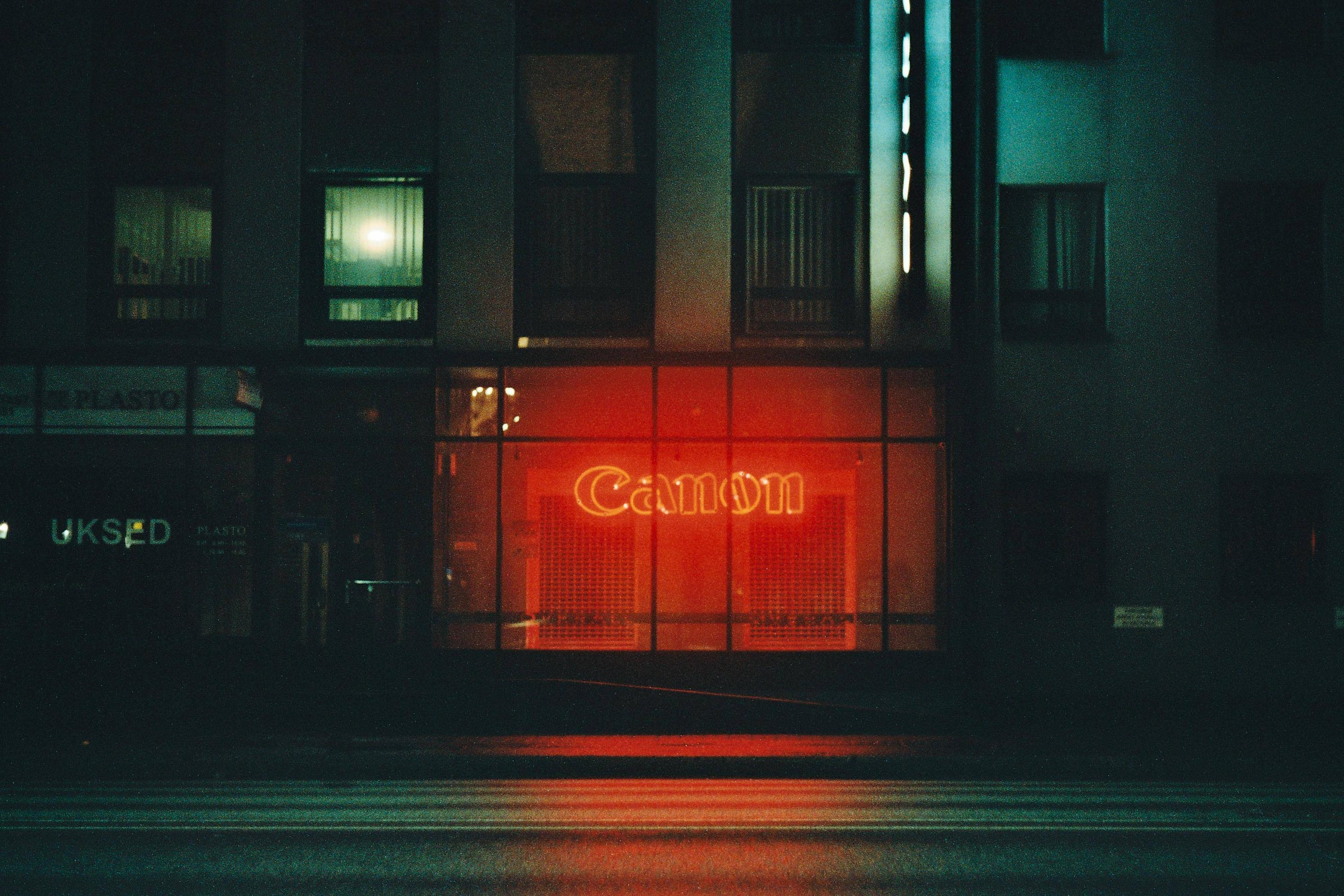 Canon neon sign in a building at night HD Wallpaper