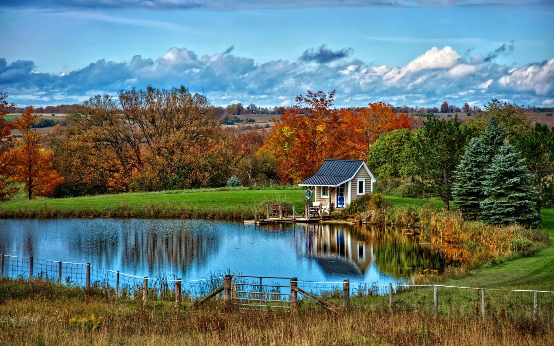 Small cabin by a lake in autumn HD Wallpaper