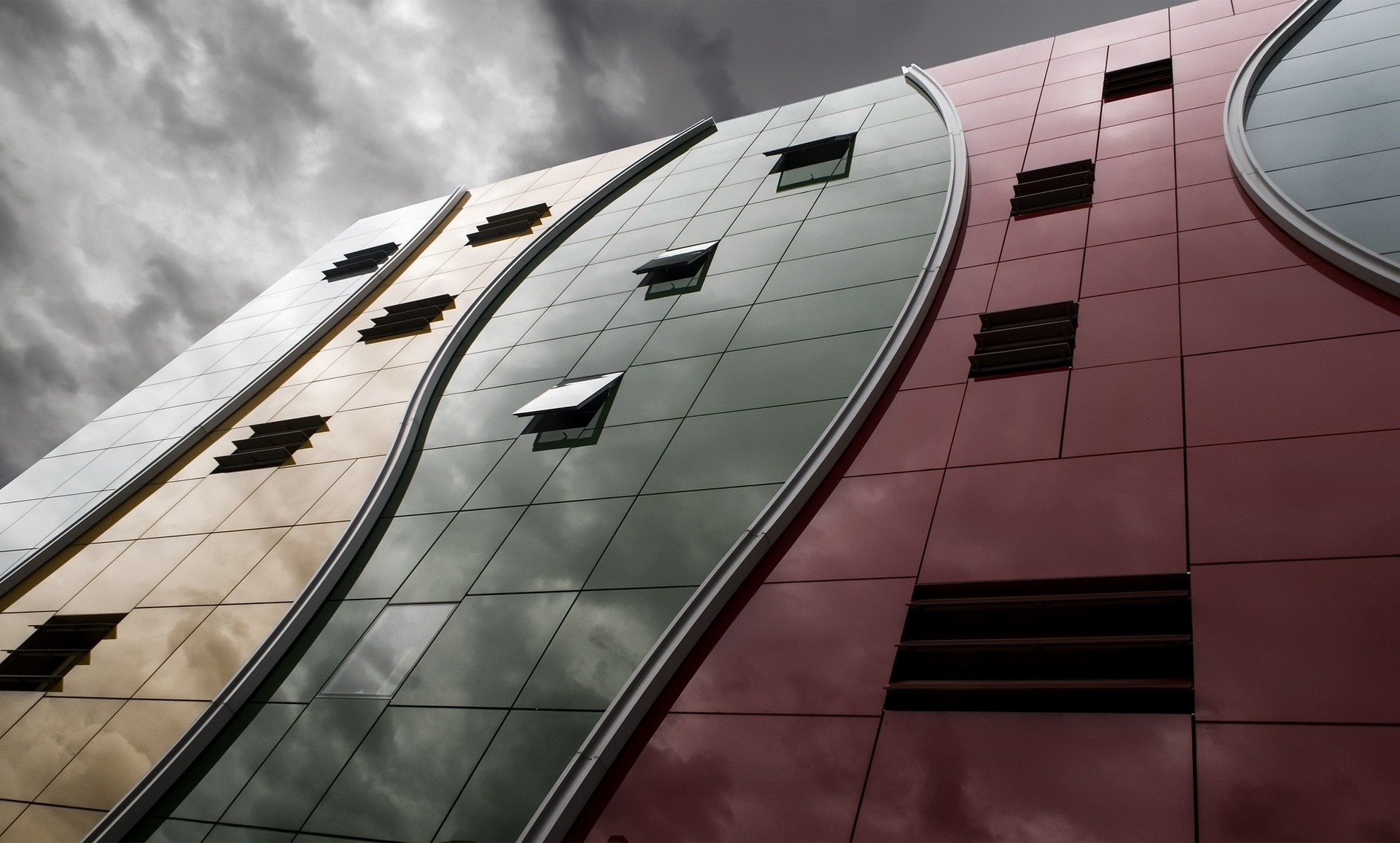 Modern building facade with wavy design and windows HD Wallpaper