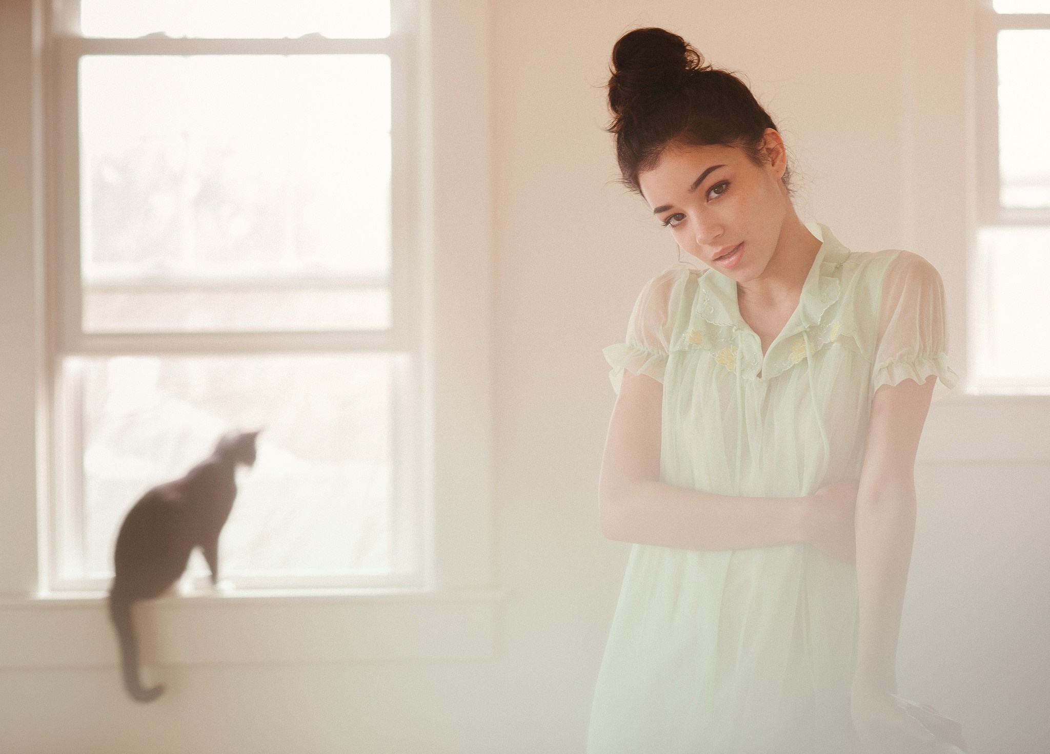 Woman in a light green dress with a cat by the window HD Wallpaper