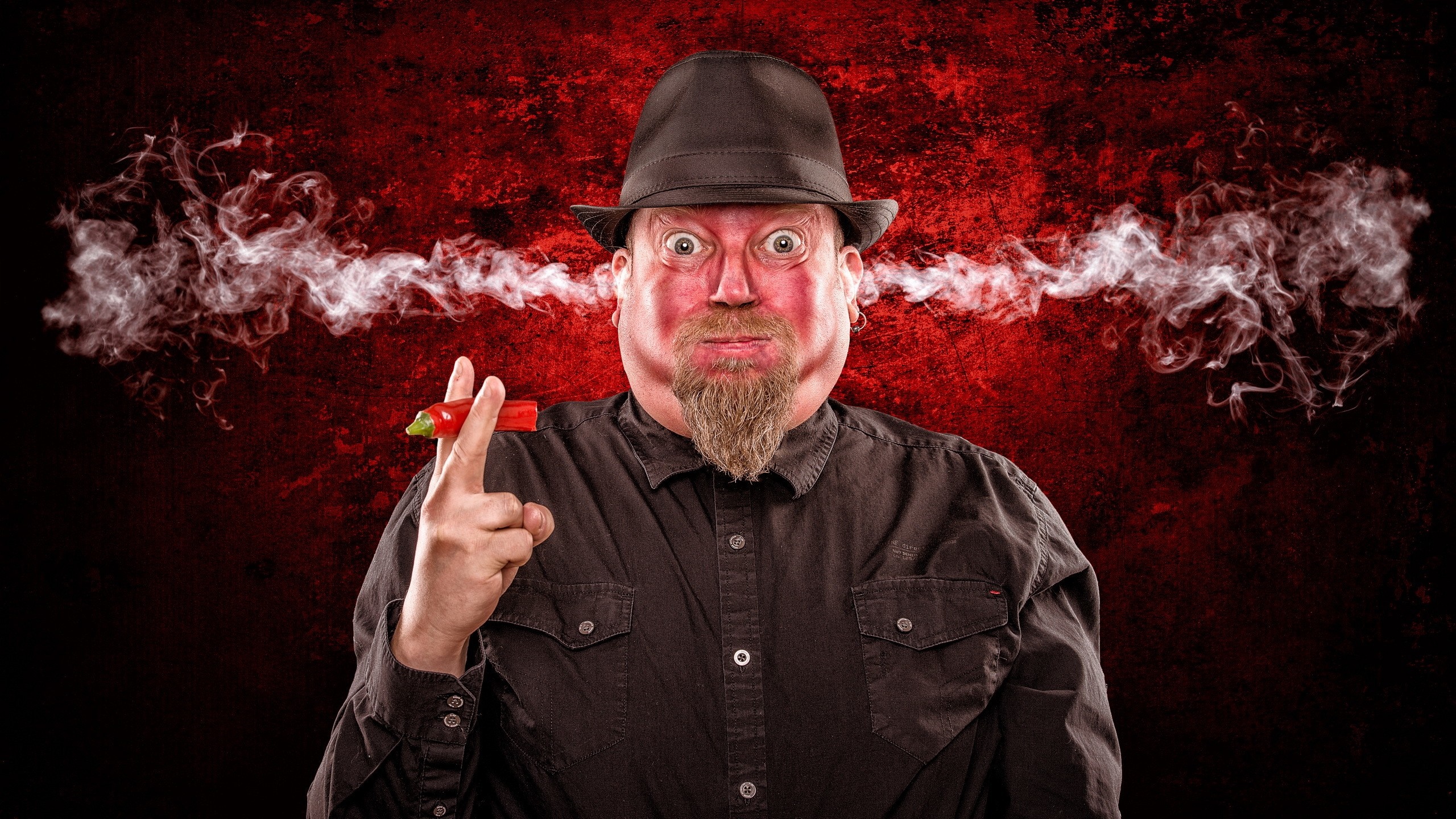 Man with chili pepper and smoke from ears HD Wallpaper