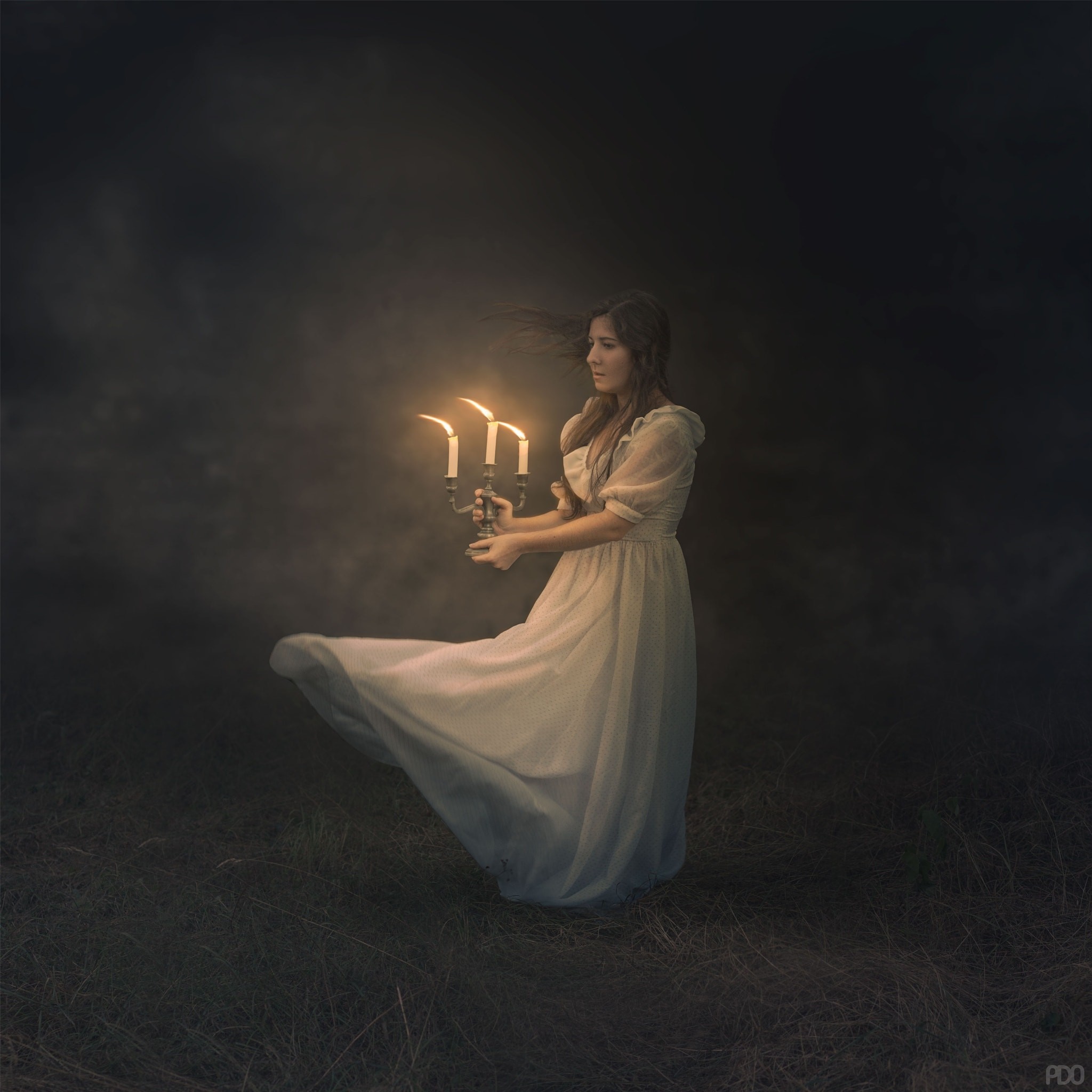 Woman holding candelabra in dark field HD Wallpaper