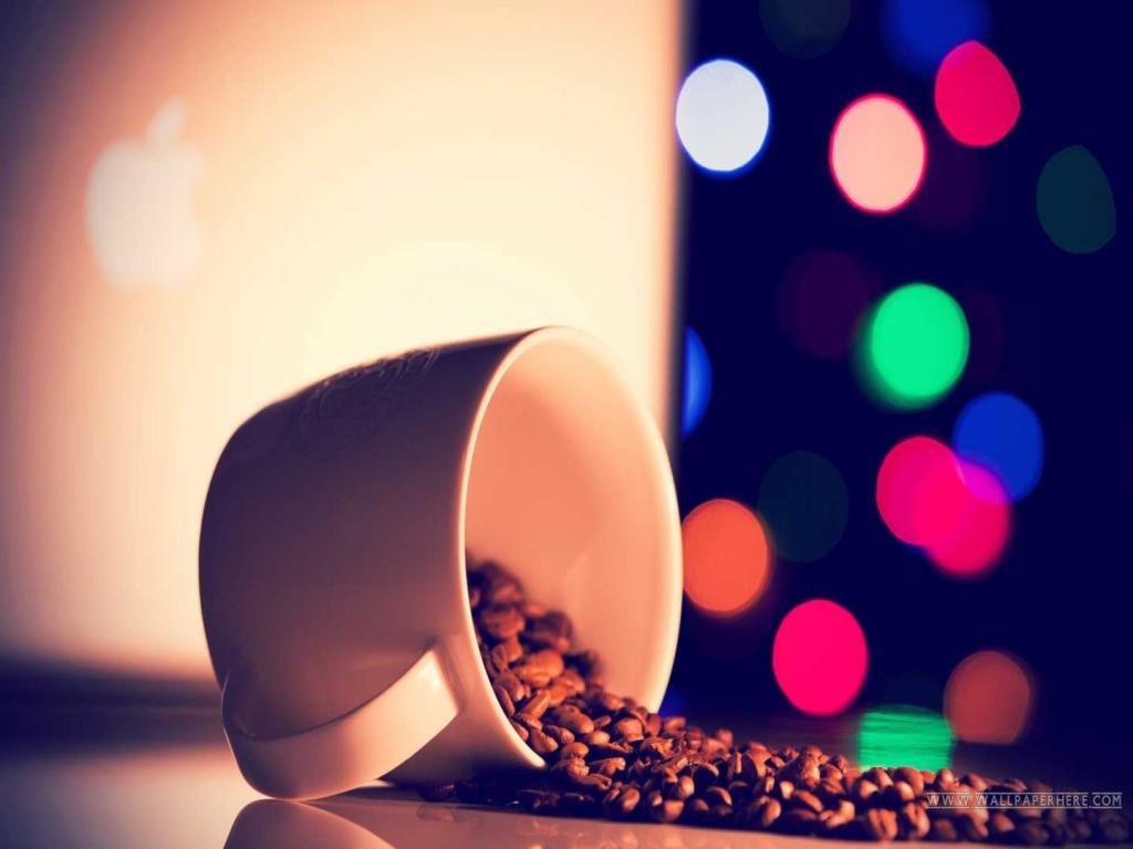Coffee beans spilling from a cup with bokeh lights HD Wallpaper