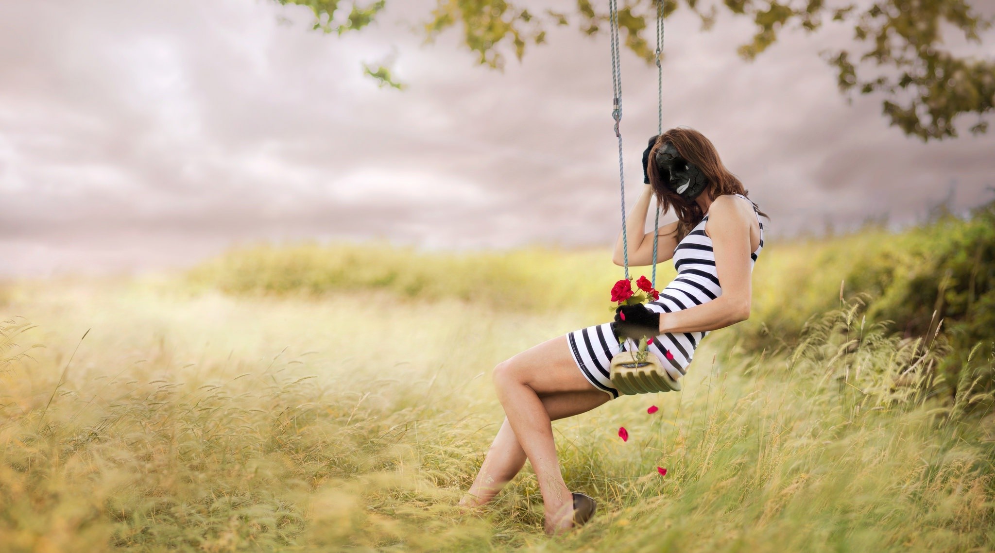 Woman with mask on swing holding roses HD Wallpaper