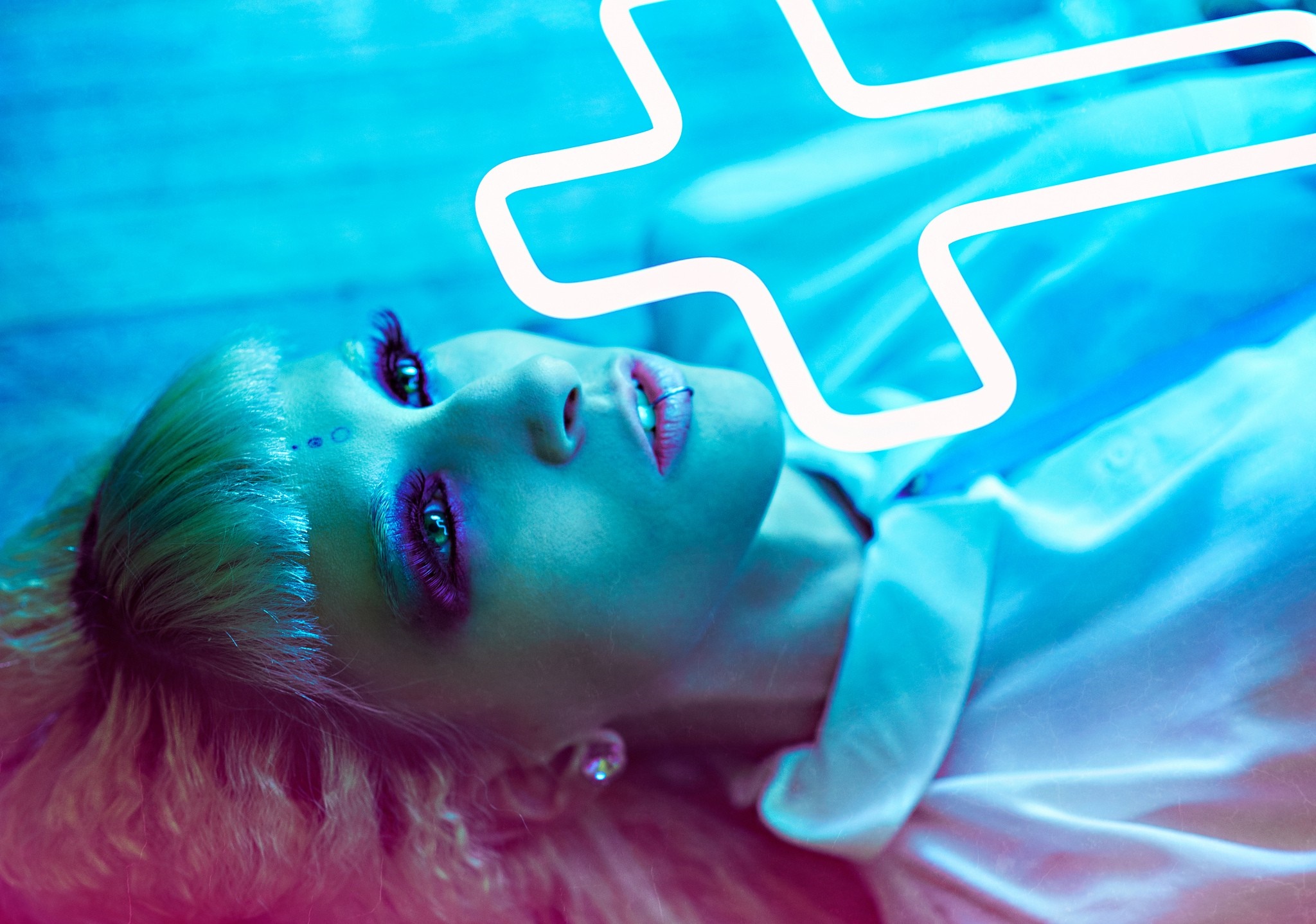 Woman with neon makeup and piercing lying down HD Wallpaper