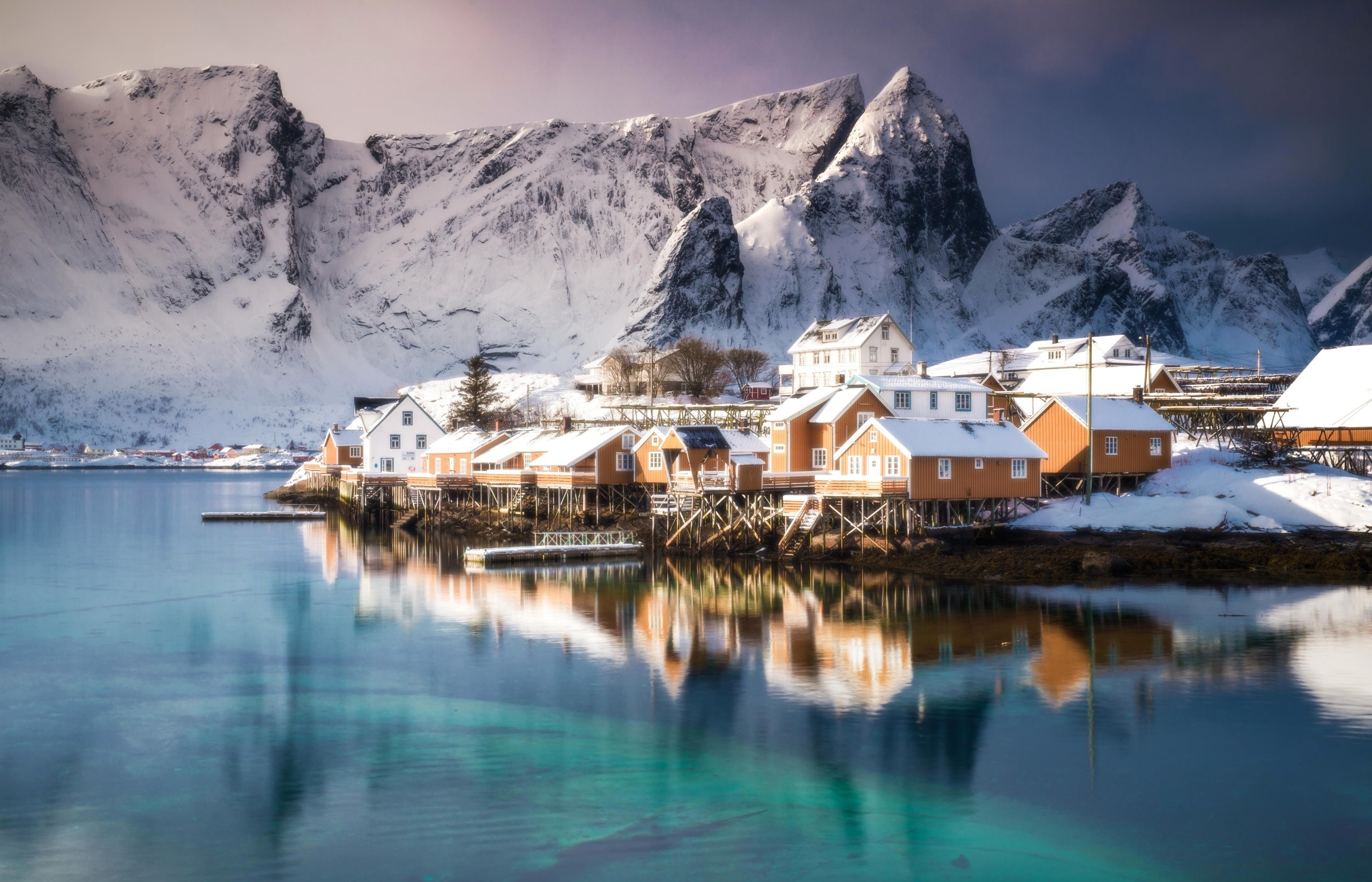 Snowy Lofoten Islands village with mountains and reflection HD Wallpaper