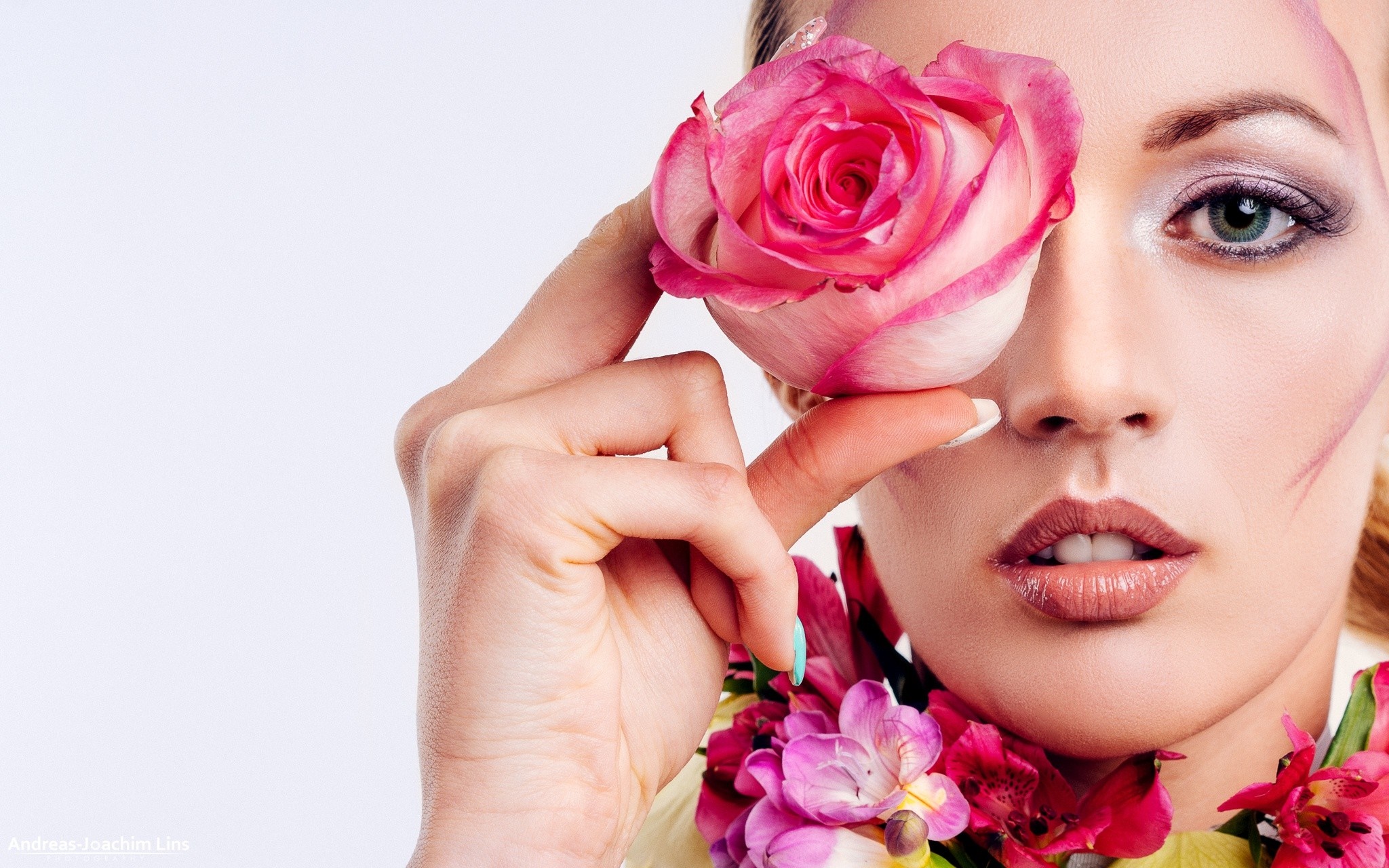 Woman with pink rose covering eye and flowers HD Wallpaper