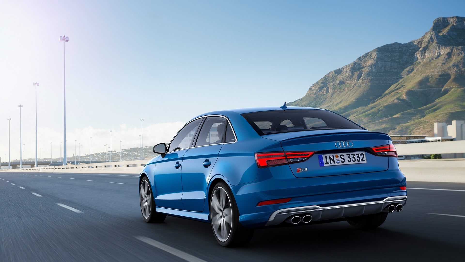 Blue Audi S3 Sedan driving on a highway with mountains HD Wallpaper